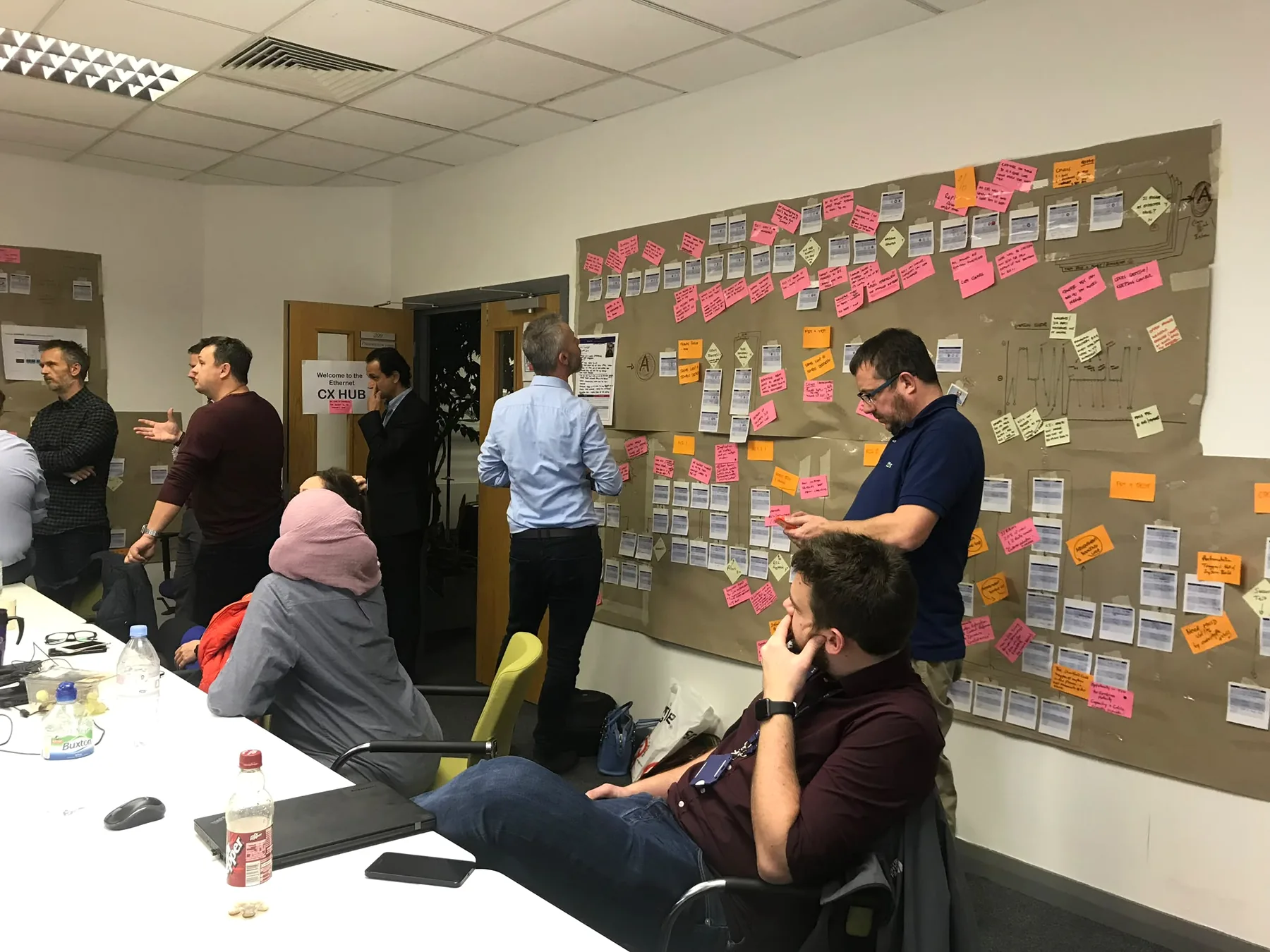 Newgate and client team reviewing a wall-based process map